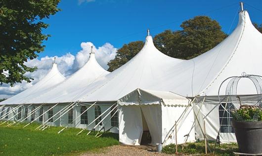 a line of sleek and modern portable toilets ready for use at an upscale corporate event in Saxapahaw